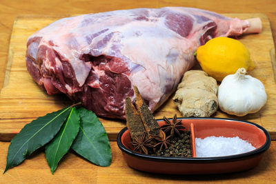 Close-up of meat with spices on cutting board