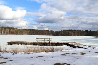Scenic view of lake against sky during winter