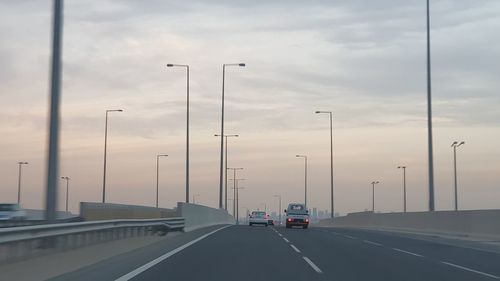 Cars on road against sky