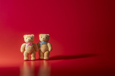 Close-up of stuffed toy against red background