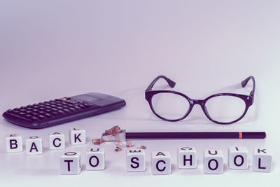 Close-up of eyeglasses on table against white background