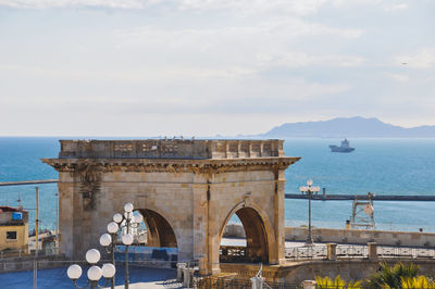 Arch monument over sea