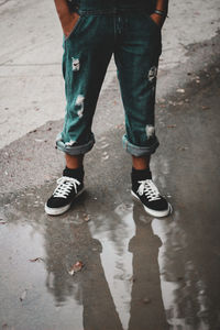 Low section of man standing on street