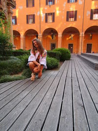 Full length of woman sitting outdoors