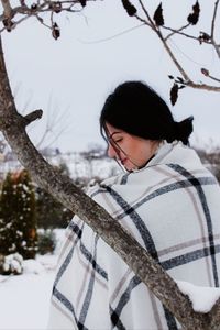 Portrait of young woman on snow covered land