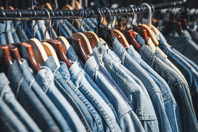 Row of denim shirts on rack at store