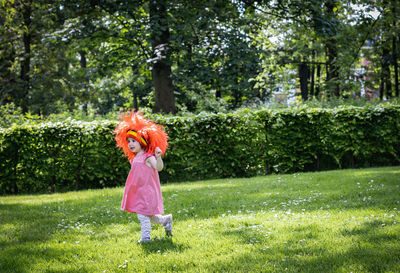 Portrait of a girl with a belgian flag wig in the park.