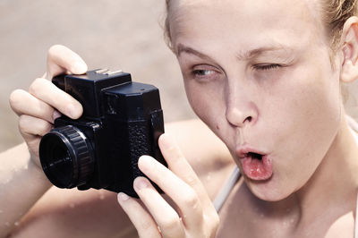 Close-up of woman holding camera