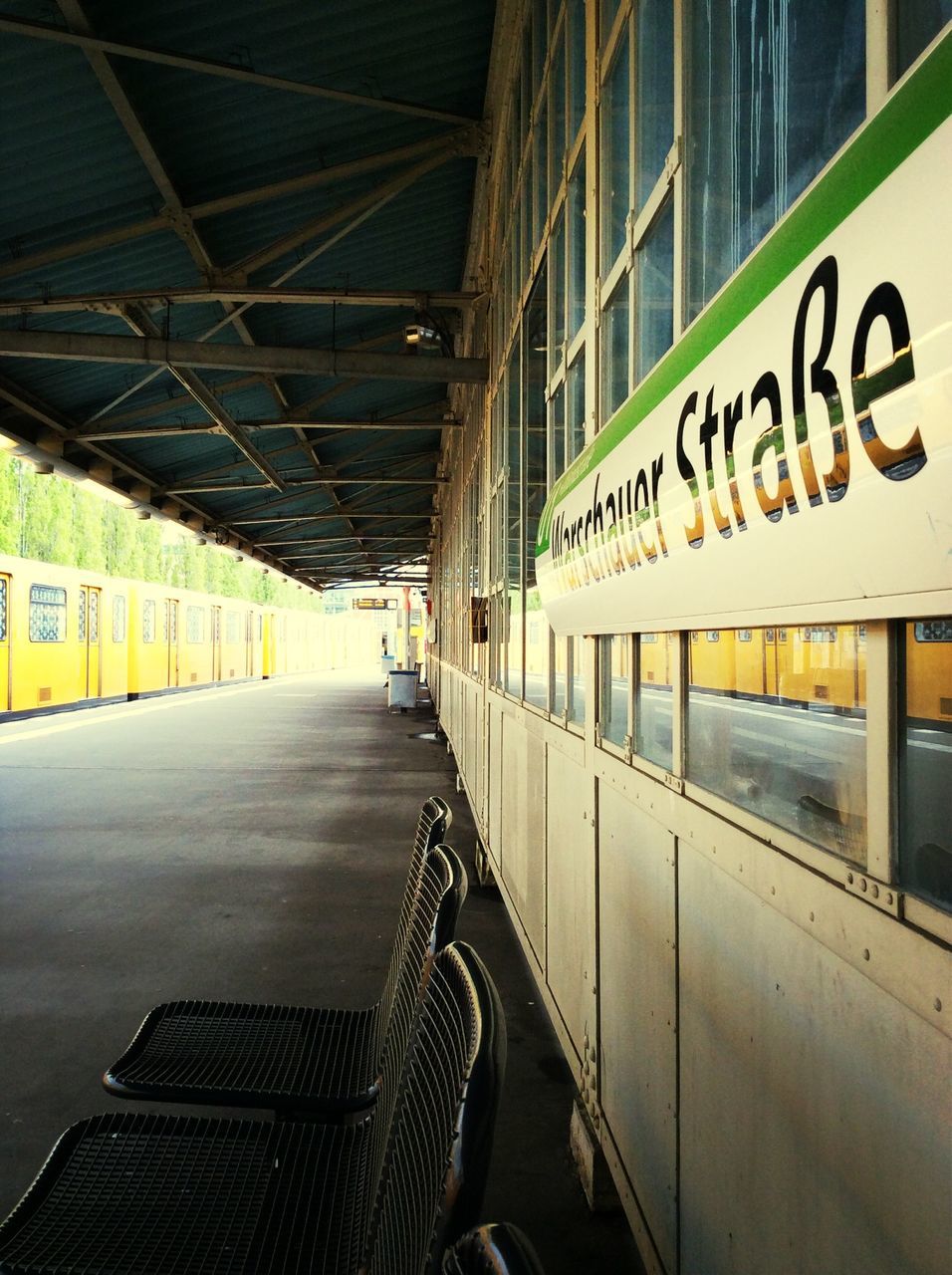 text, western script, communication, transportation, the way forward, built structure, architecture, graffiti, information sign, sign, empty, capital letter, diminishing perspective, railing, wall - building feature, arrow symbol, railroad station, information, no people, guidance