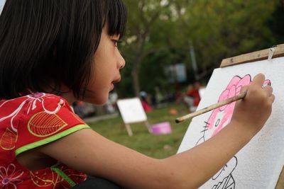 Close-up of girl drawing on paper