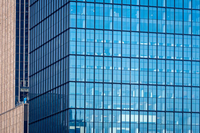 Close-up of glass office building facade with windows, texture, architecture