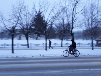 Man with bicycle in winter