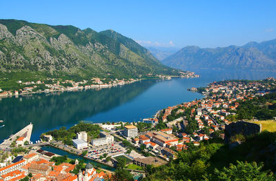 Houses by river and mountains at kotor bay