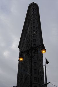 Low angle view of building against cloudy sky