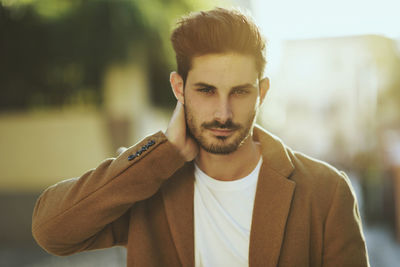 Portrait of handsome young man standing outdoors