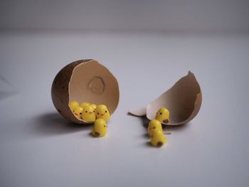 Close-up of yellow toy over white background