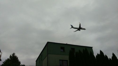 Low angle view of airplane flying in sky