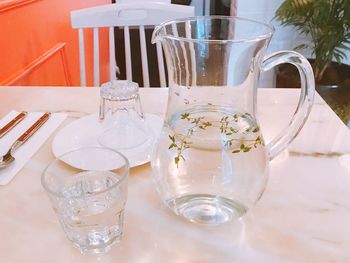 Water with herb in jug on table