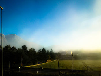 Scenic view of field against sky and fog