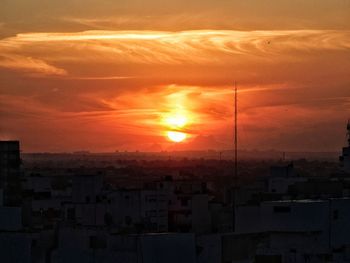 Aerial view of townscape against sky during sunset