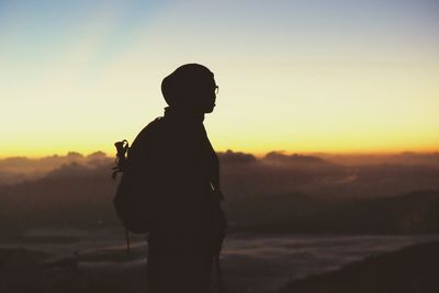 Silhouette of woman standing on landscape