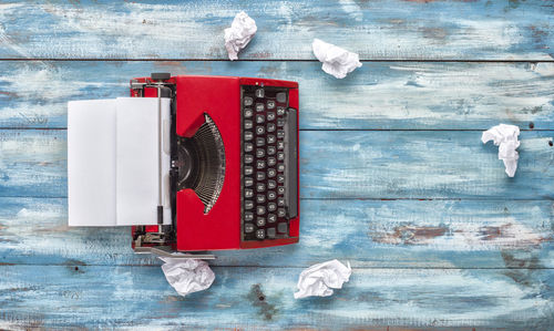 High angle view of typewriter amidst papers on table