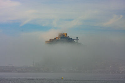 Castle in sea against sky