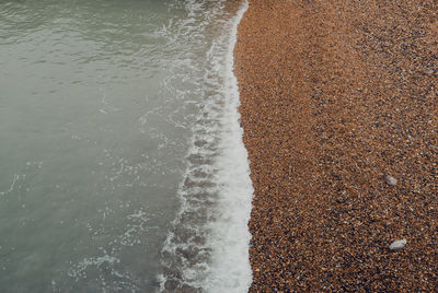 High angle view of waves rushing towards shore