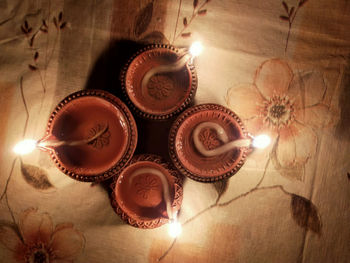 High angle view of lit candles on table