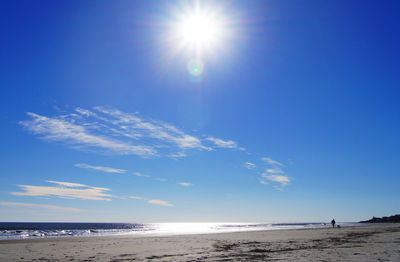 Scenic view of beach against blue sky