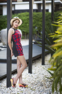 Portrait of smiling young woman standing outdoors