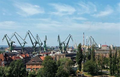 Cityscape by sea against sky