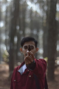 Portrait of woman photographing outdoors