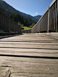 Surface level of boardwalk on footpath against sky