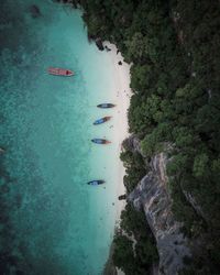 Aerial view of boats moored on shore at beach