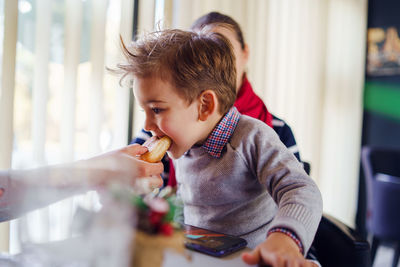 Portrait of boy eating food