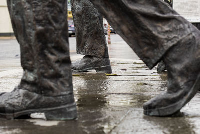 Low section of man reflection in puddle