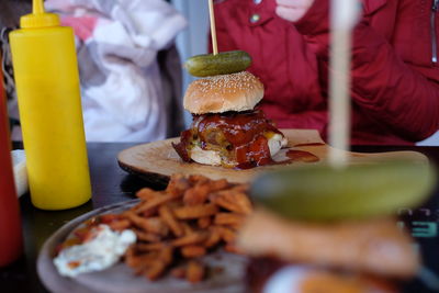 Burger on serving tray at table