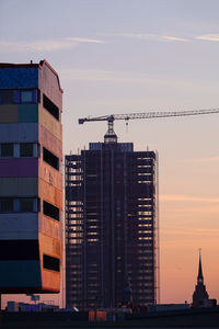 View of buildings in city at sunset