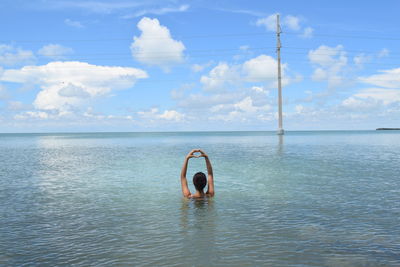 Person in sea against sky
