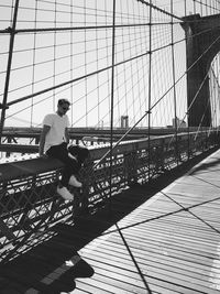 Man sitting on brooklyn bridge 