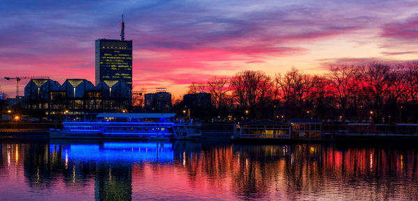 Reflection of buildings in river during sunset