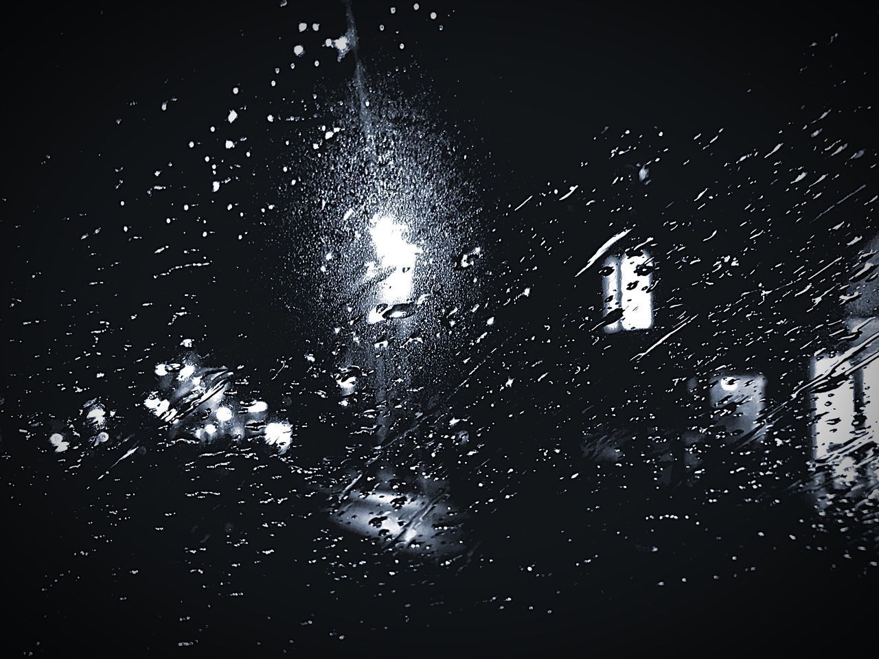 LOW ANGLE VIEW OF WET WINDOW AT NIGHT