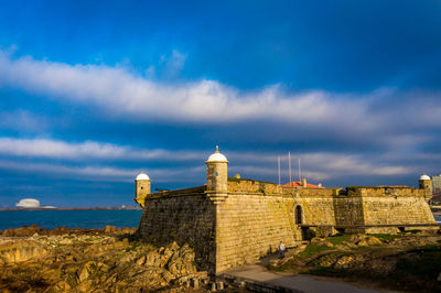 Castle against cloudy sky