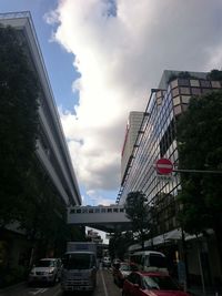 Traffic on road against cloudy sky