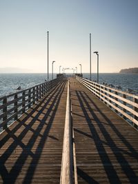 Pier over sea against clear sky