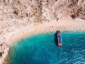 High angle view of man on rock in sea