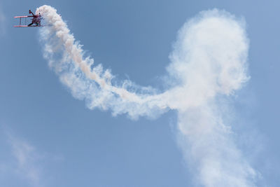 Low angle view of vapor trail against sky