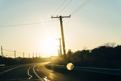 Electricity pylon against sky during sunset