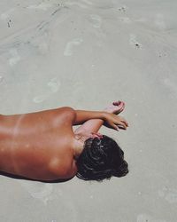 Close-up of woman lying on beach